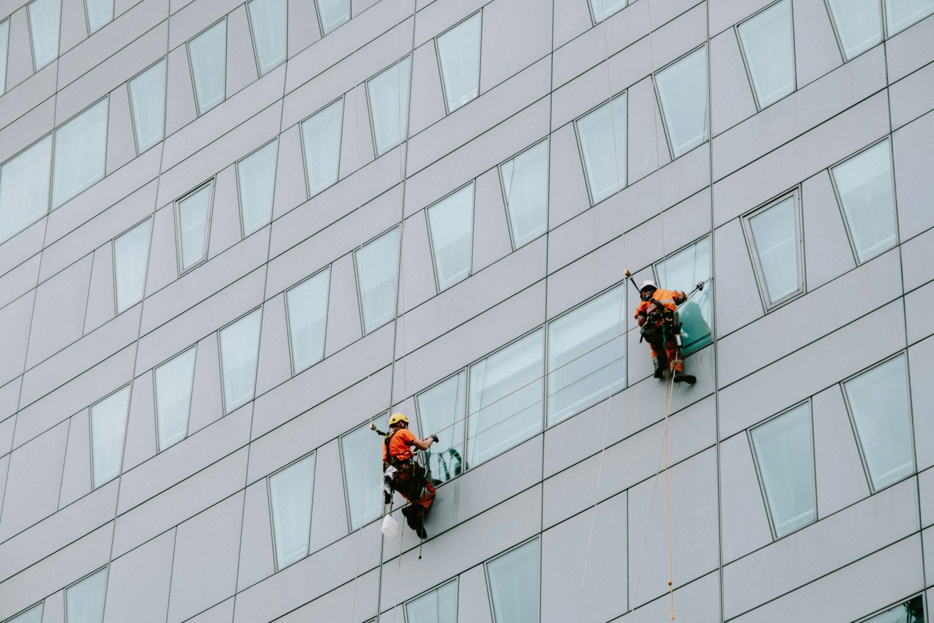 a few men climbing a building